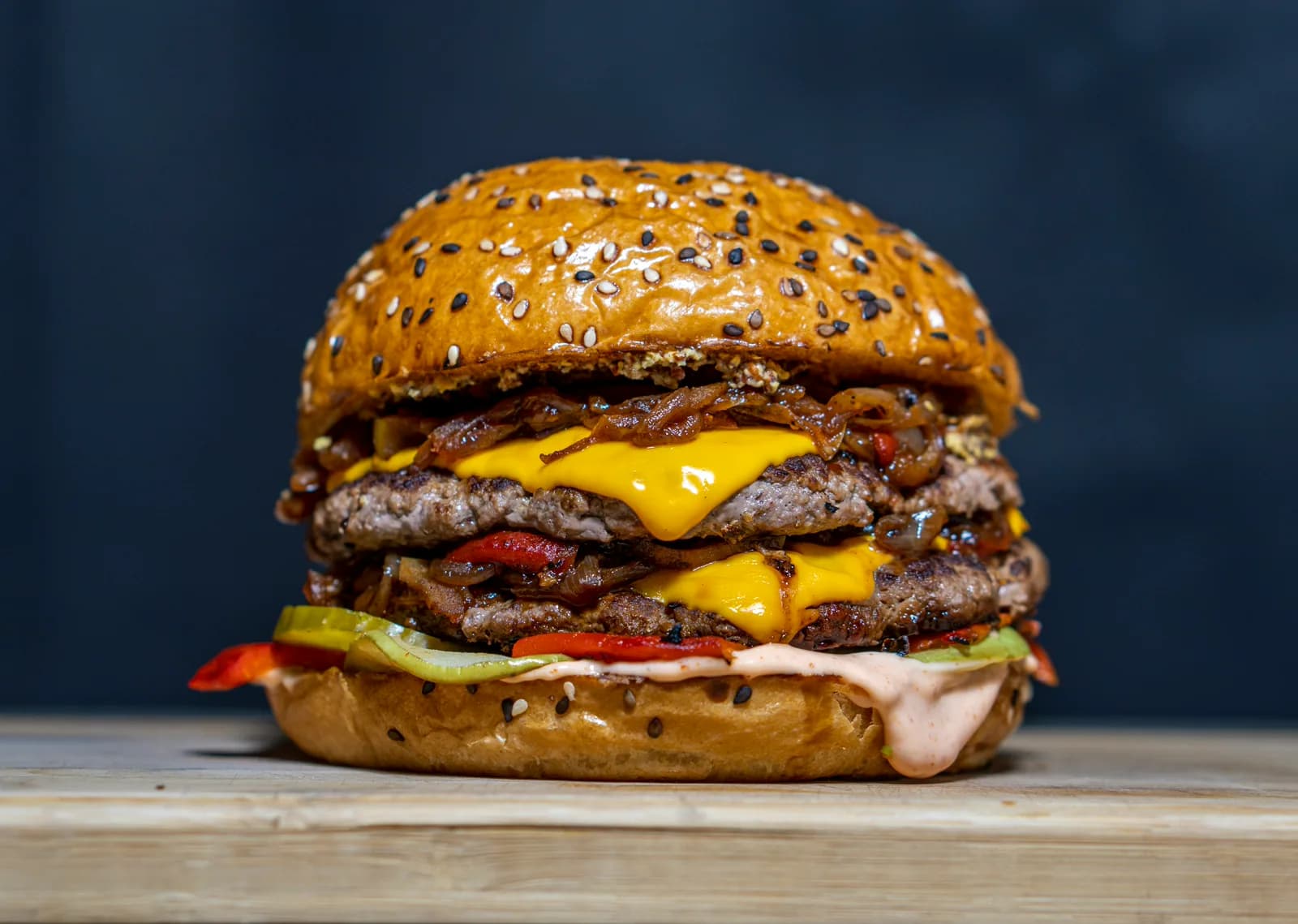 Double smash cheeseburger with melted cheddar and caramelized onions on a seeded bun